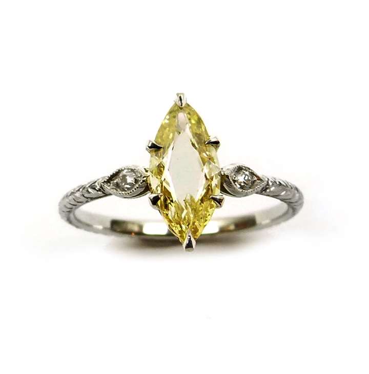 Single stone fancy yellow marquise portrait cut diamond ring, the 0.61ct stone claw set